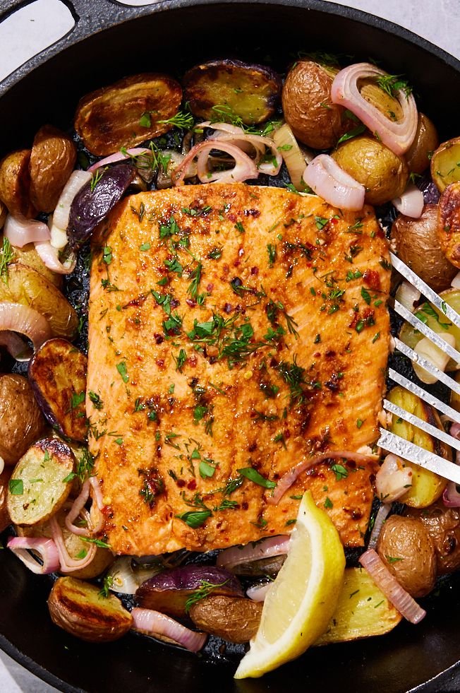 A salmon and potato dish in a skillet.