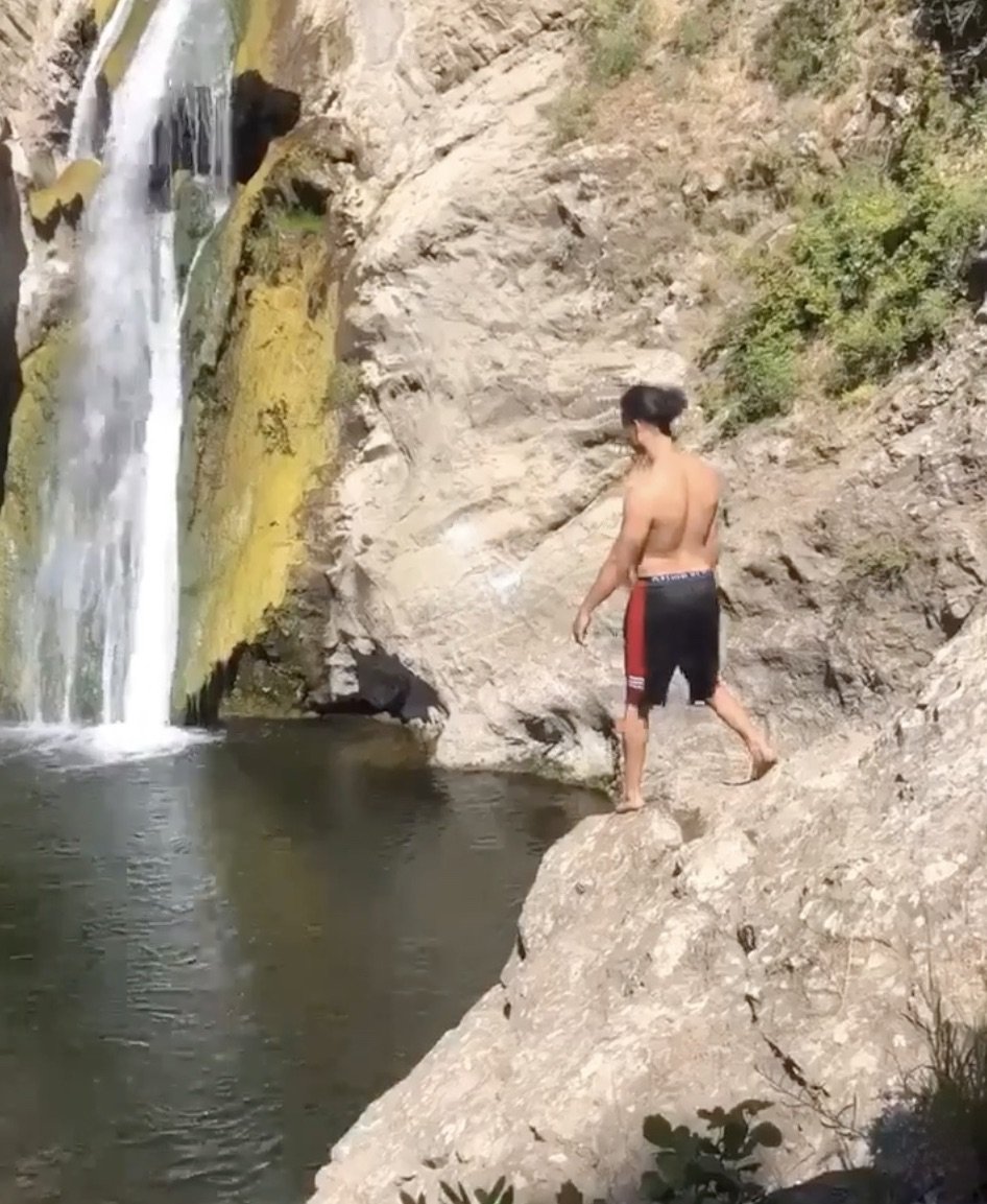 A man jumping off a cliff at Paradise Falls