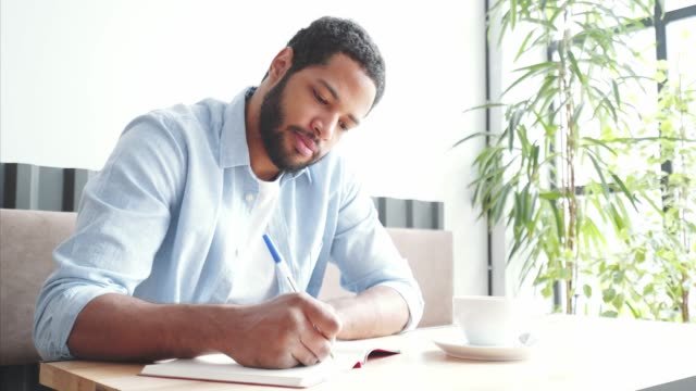 A black male journaling 