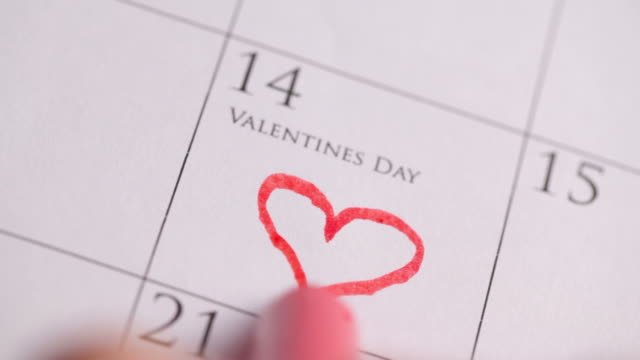 A calendar with a red heart drawn on the date of Feb. 14th. 