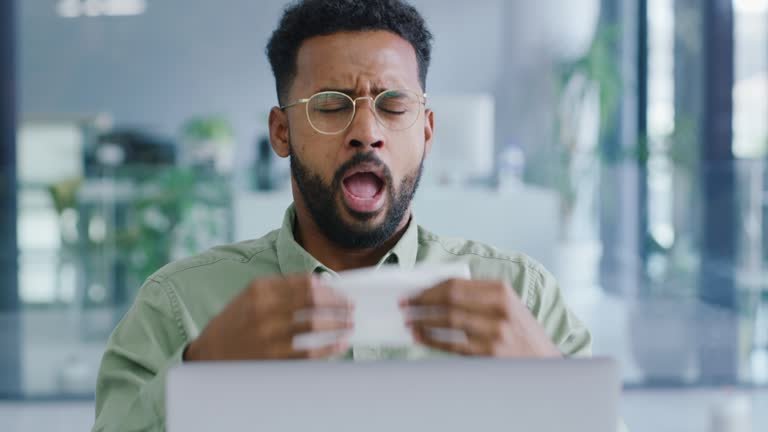 A fly black male getting ready to sneeze into a kleenex 