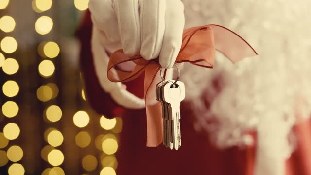 Santa giving someone house keys.  