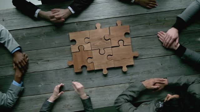 Business people solving a puzzle 