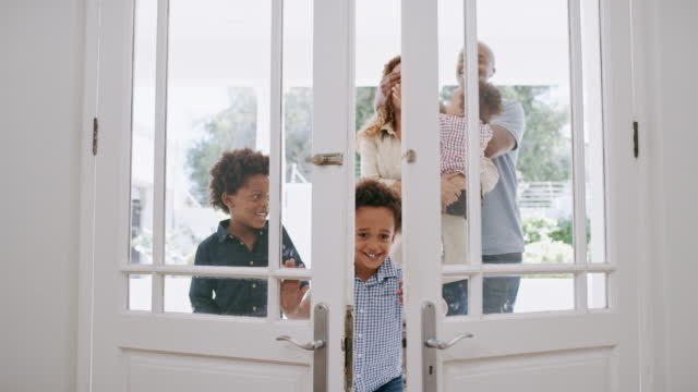 A family walking thru doors to their new home. 
