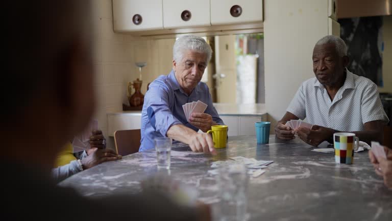 An older couple playing cards.