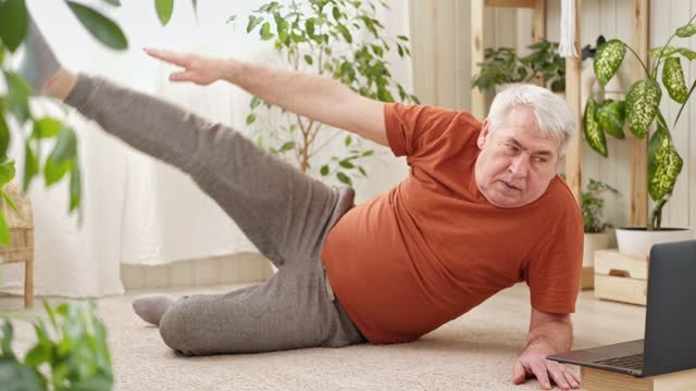 A man laying on the floor stretching 