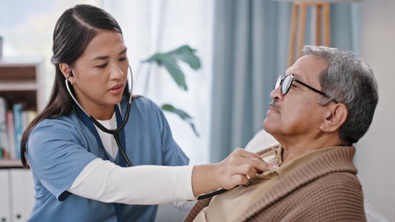 An elderly man getting a check up from a doctor