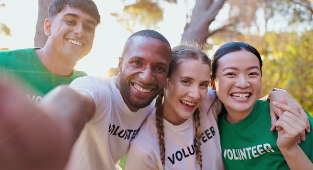 A group of volunteers wearing green or white shirts