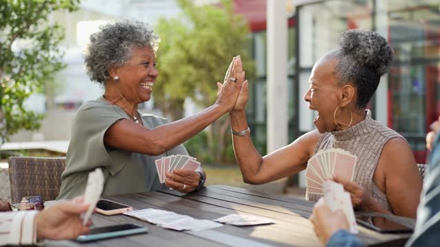 Two ladies giving each other a high five.