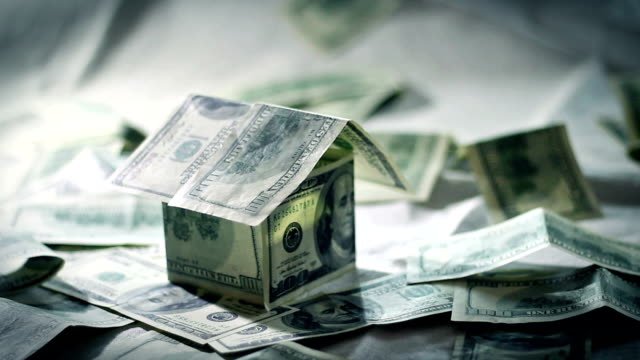 Money folded into the shape of a house