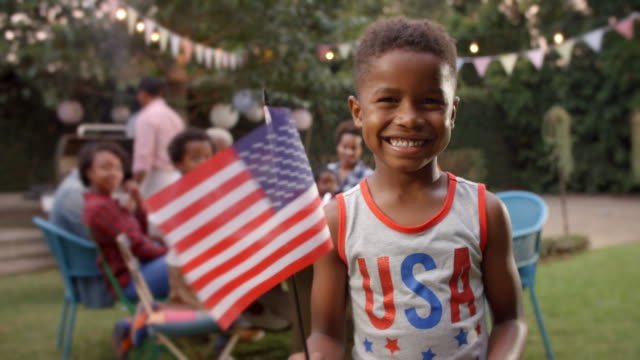 A little boy with a USA tank top on