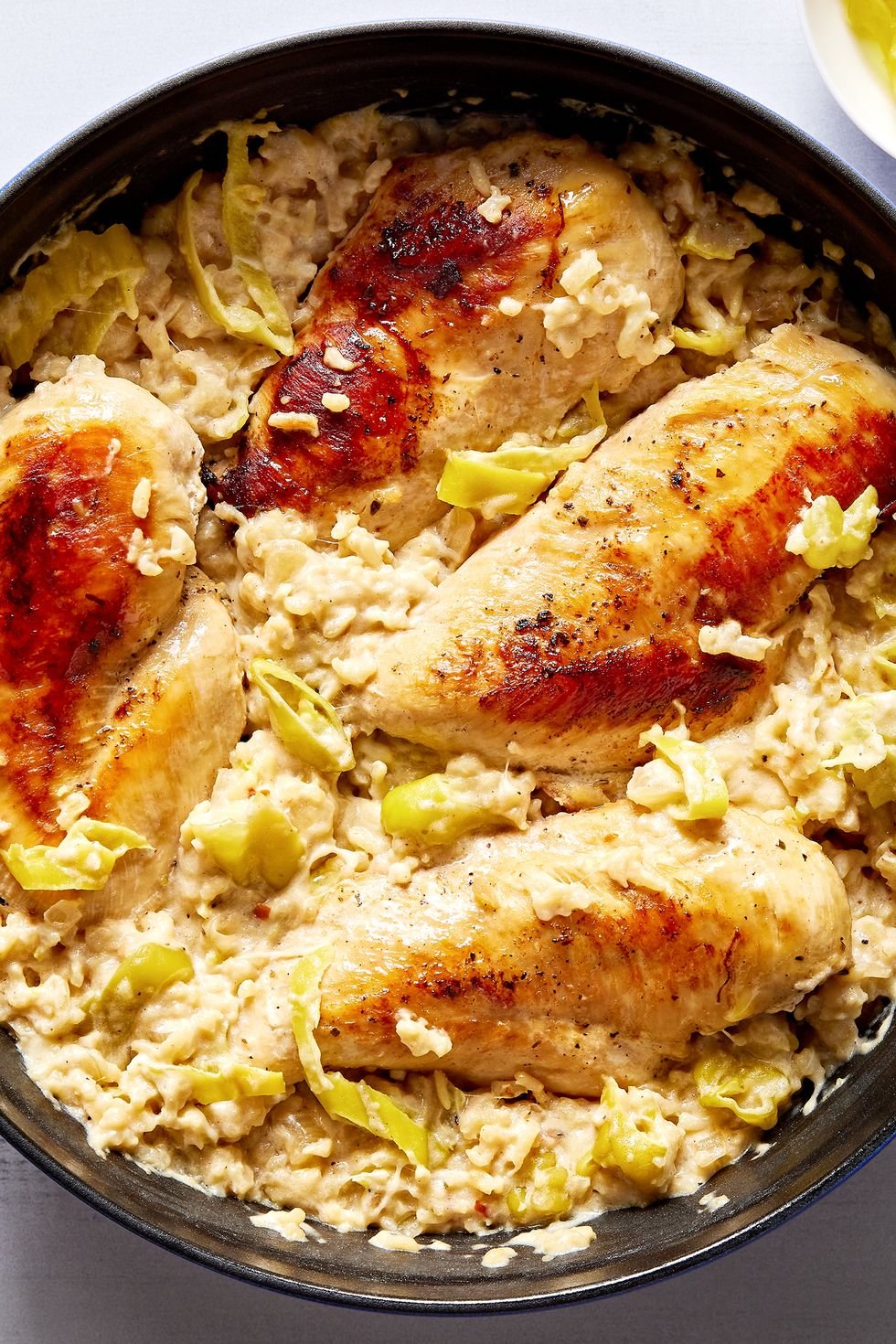 A chicken, pepper and rice dish in a pan.